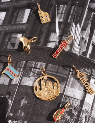 Solid gold chicago inspired charms laying on an old black and white photos