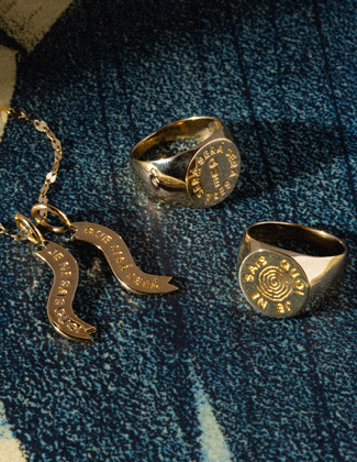 Gold jewelry on a dark blue surface