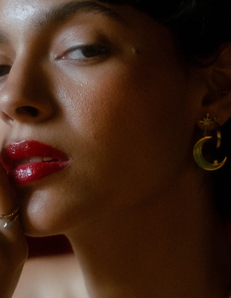 Close up of a woman wearing gold earrings