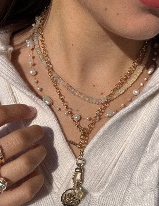 Close up of a woman wearing several necklace