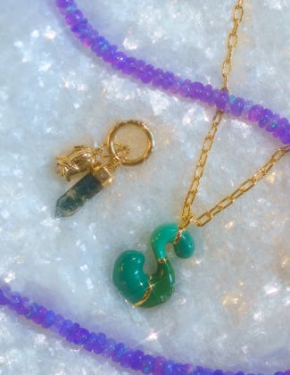 gold gemstone jewelry laying in faux snow