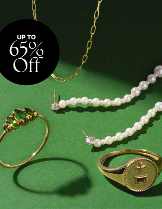 Close up of gold and gemstone necklace on a green background with a badge that reads 