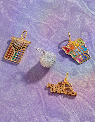 gemstone and gold charms on an iridescent marbled purple background