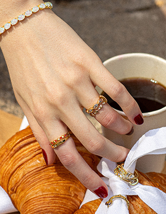 A selection of ring clips and stacking rings on a zoomed in hand showcasing natural beauty and showcasing well lit jewelry