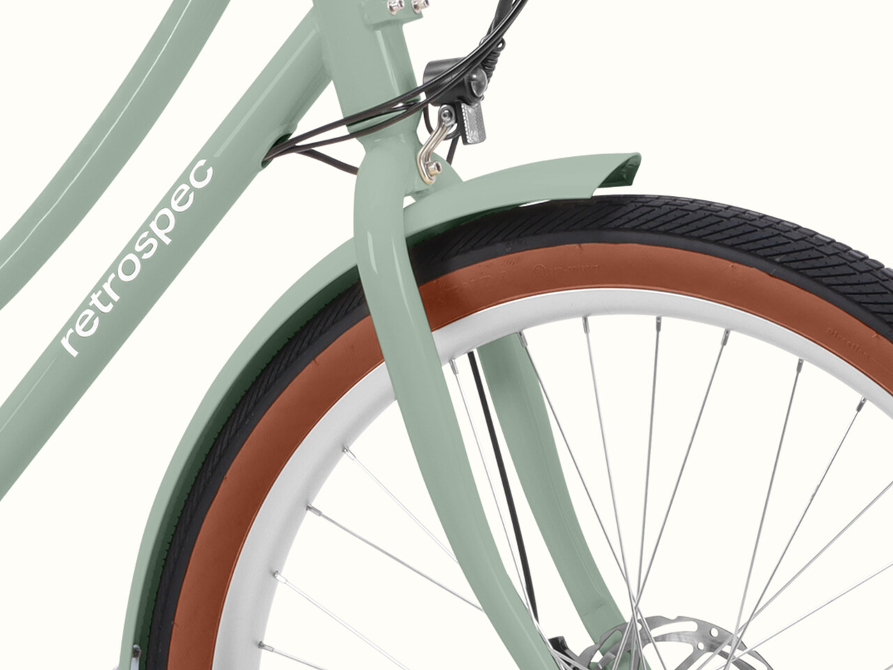 Close-up of the mint Beaumont Rev 3 City Electric Bike - Step Through's front fender.
