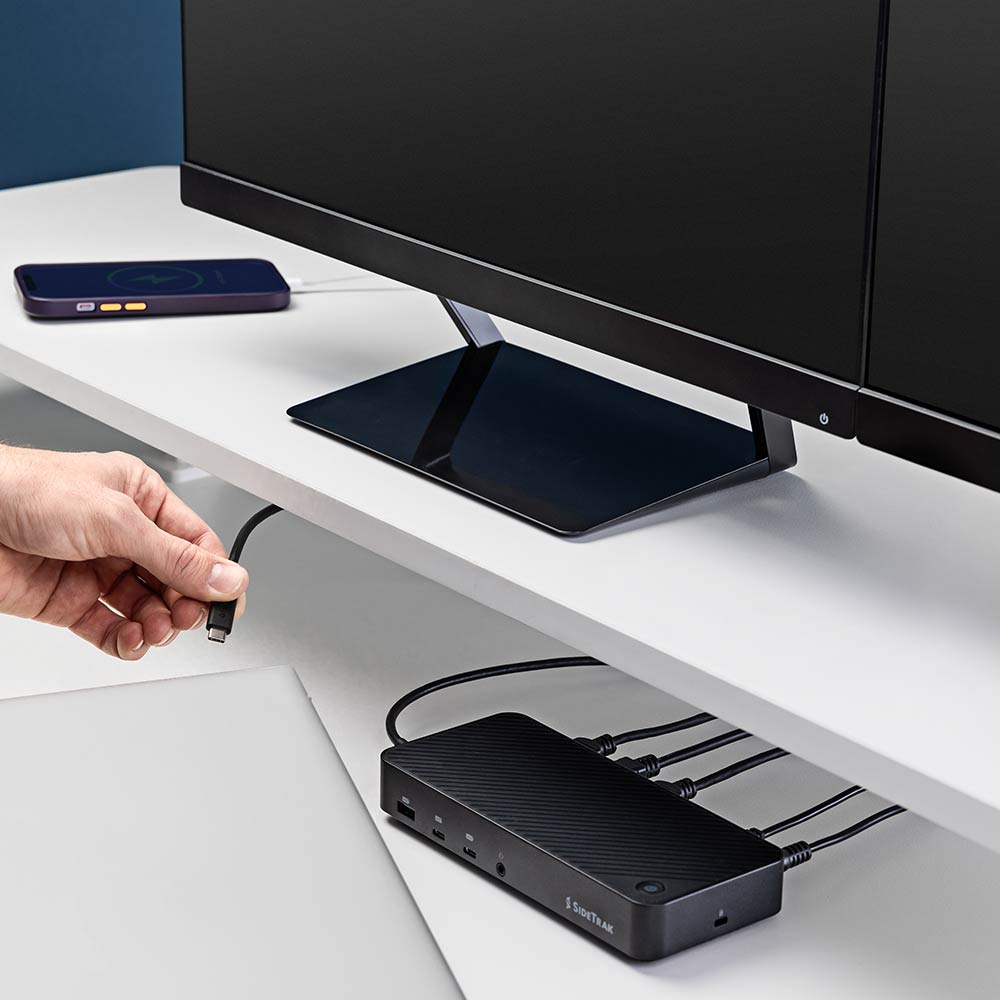 13 Port  Docking Station  SideTrak  13-Port Docking Station Hub  A user connecting a USB cable to the SideTrak docking station, emphasizing the hub's user-friendly design and its role in streamlining connectivity and workstation efficiency.