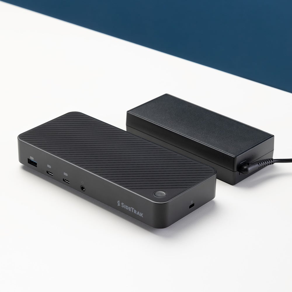 13 Port  Docking Station  SideTrak  13-Port Docking Station Hub  Showcasing the SideTrak docking station's sleek, horizontal design next to its power adapter, this image underscores the product's minimalist aesthetic and practical utility in modern home and office settings.