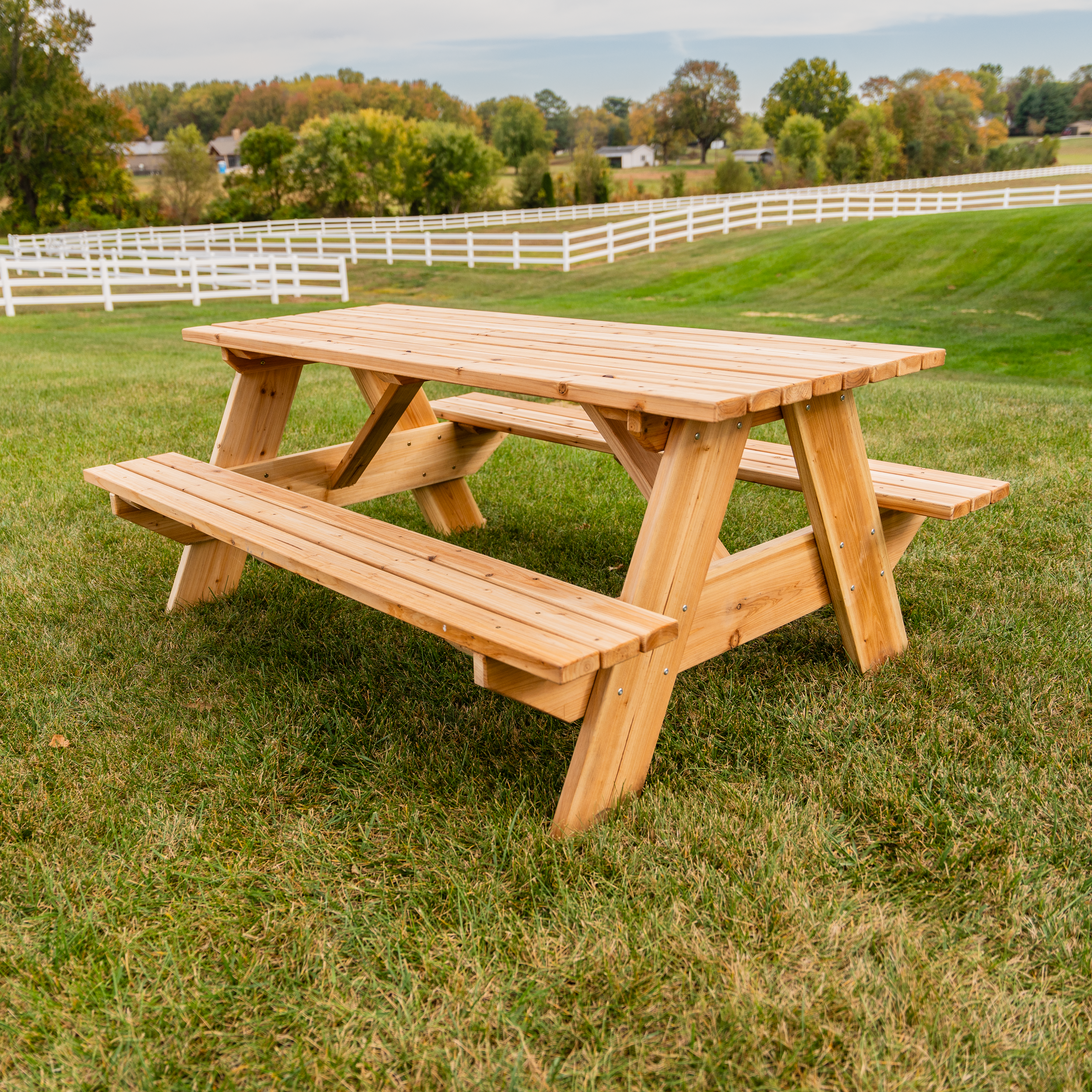 wooden picnic table in farm field