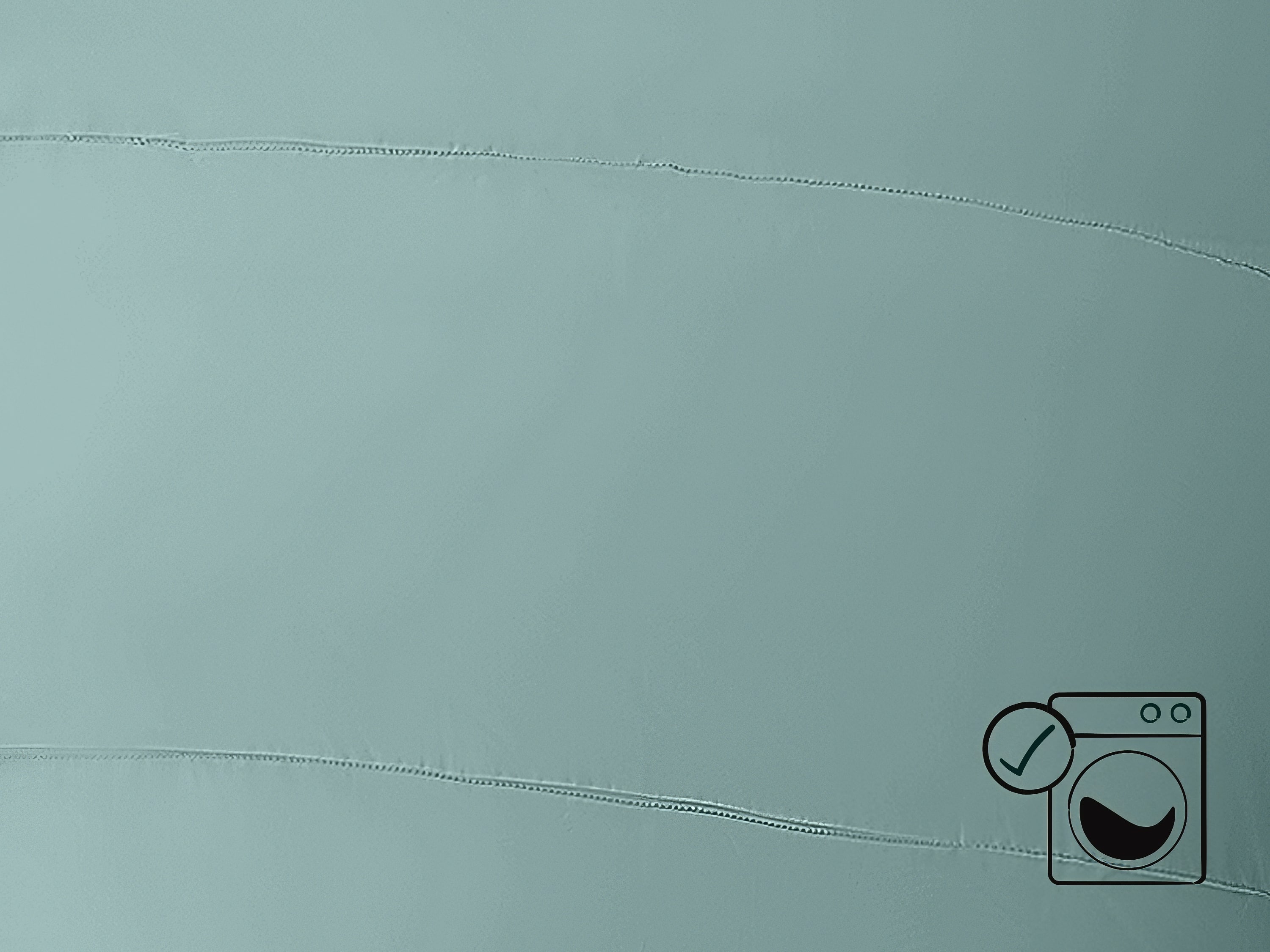 A close-up of the blue Dream Sleeping Bag with a black washing machine icon in the corner.