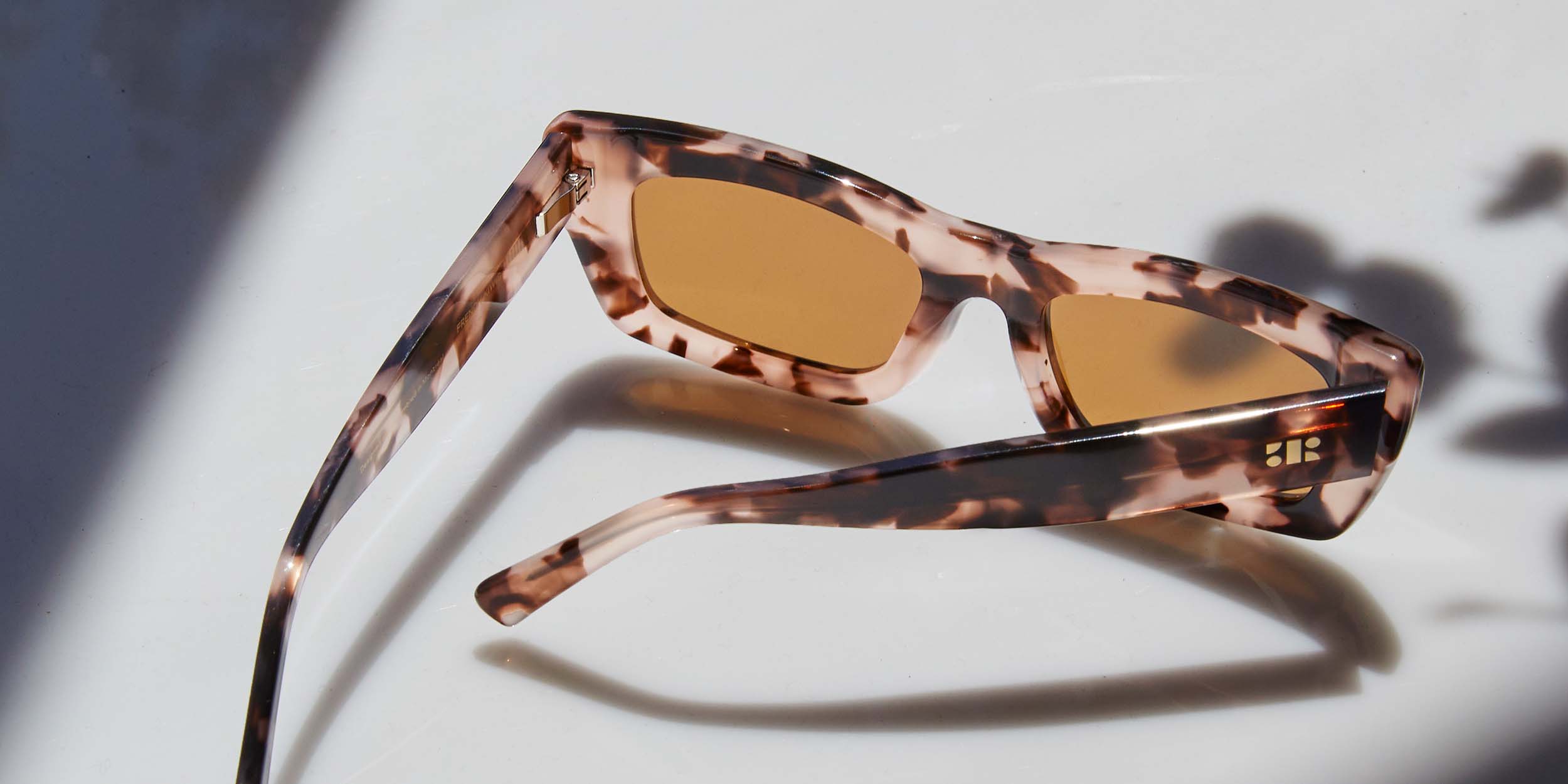 Photo Details of Agathe Sun Pink Tortoise Sun Glasses in a room