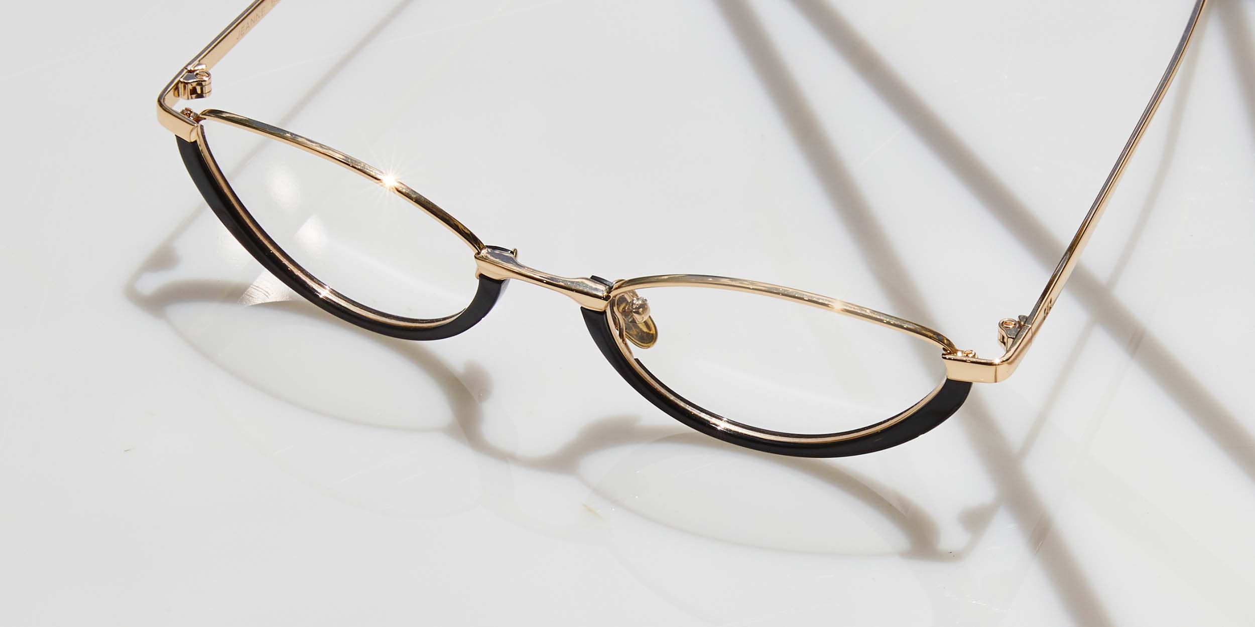 Photo Details of Jeanne Black & Gold Reading Glasses in a room