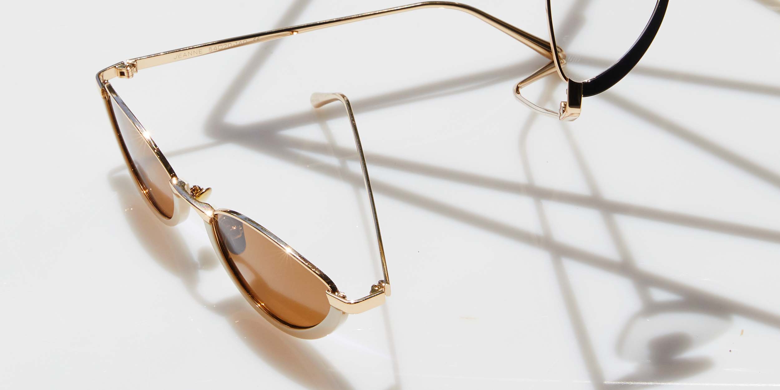 Photo Details of Jeanne Sun Tortoise & Gold Sun Glasses in a room