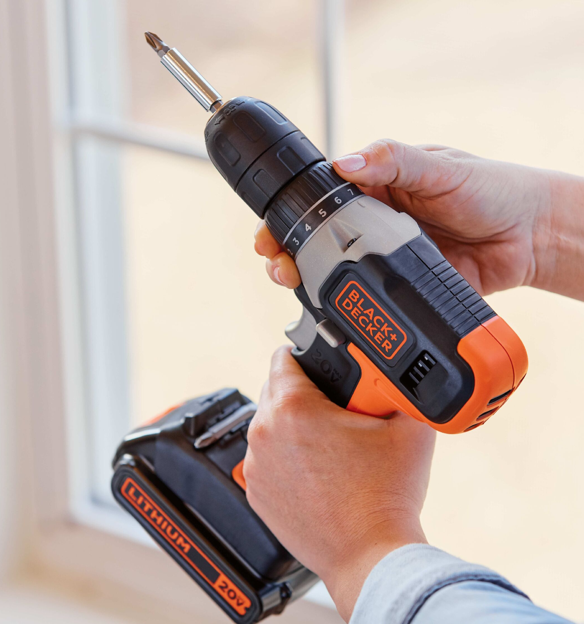 User making clutch adjustments on 11-setting clutch of a 20V Max Cordless Drill.