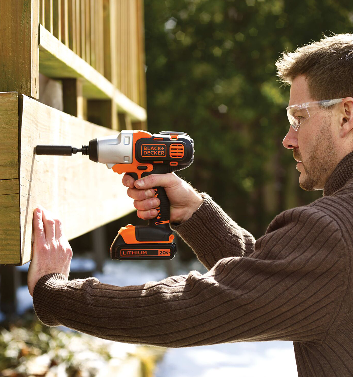 Person using a cordless Black and Decker drill