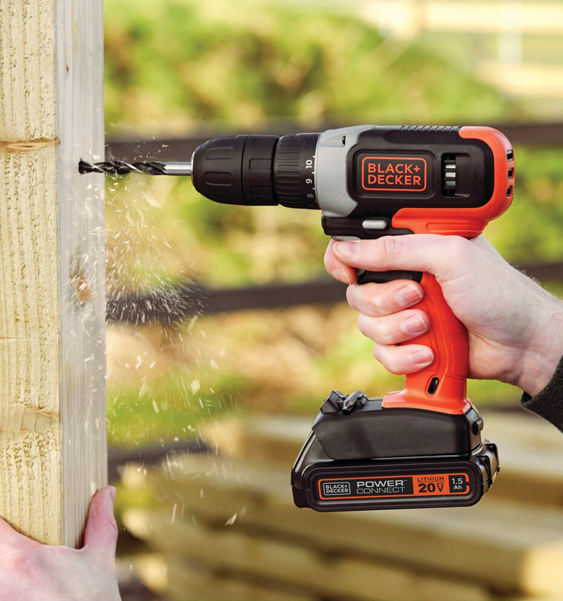 Person using a cordless Black and Decker drill