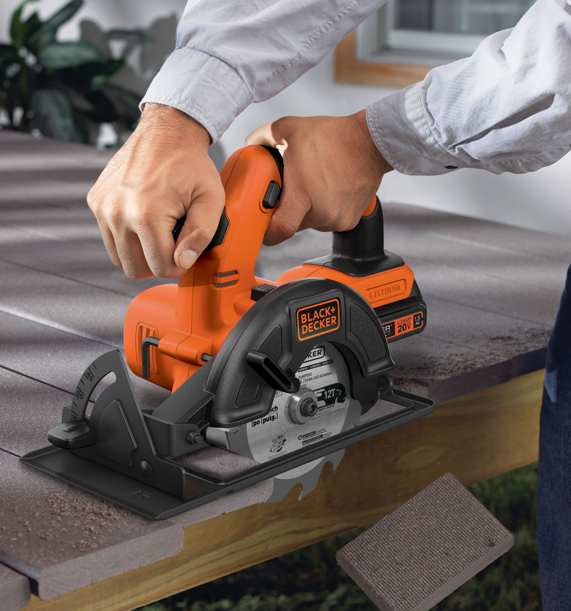 20 volt MAX 5 and half inch circular saw being used by a person to cut hard material.