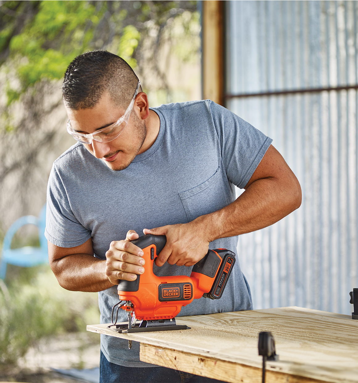 Man using 20V Max Powerconnect Cordless Jig Saw to cut wood in a workshop.