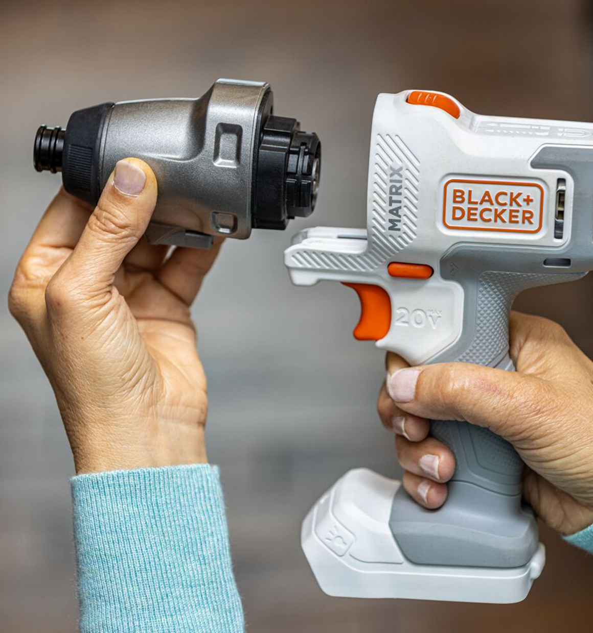 Person shows how the BLACK+DECKER MATRIX Impact Driver attachment slides on to the BLACK+DECKER 20 Volt MATRIX Power Unit.