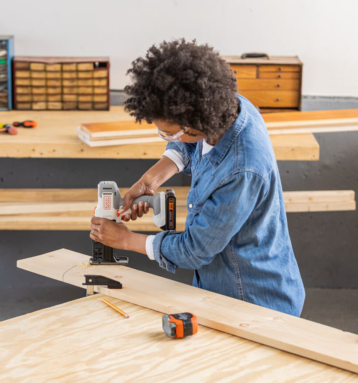 Person uses the BLACK+DECKER MATRIX jig saw attachment to cut curves in wood material