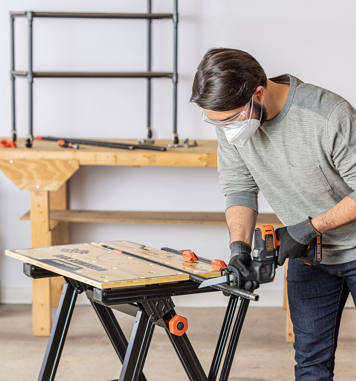 Black and Decker MATRIX Reciprocating Saw Accessory For Cordless Drill being used by a person to cut a metal rod.