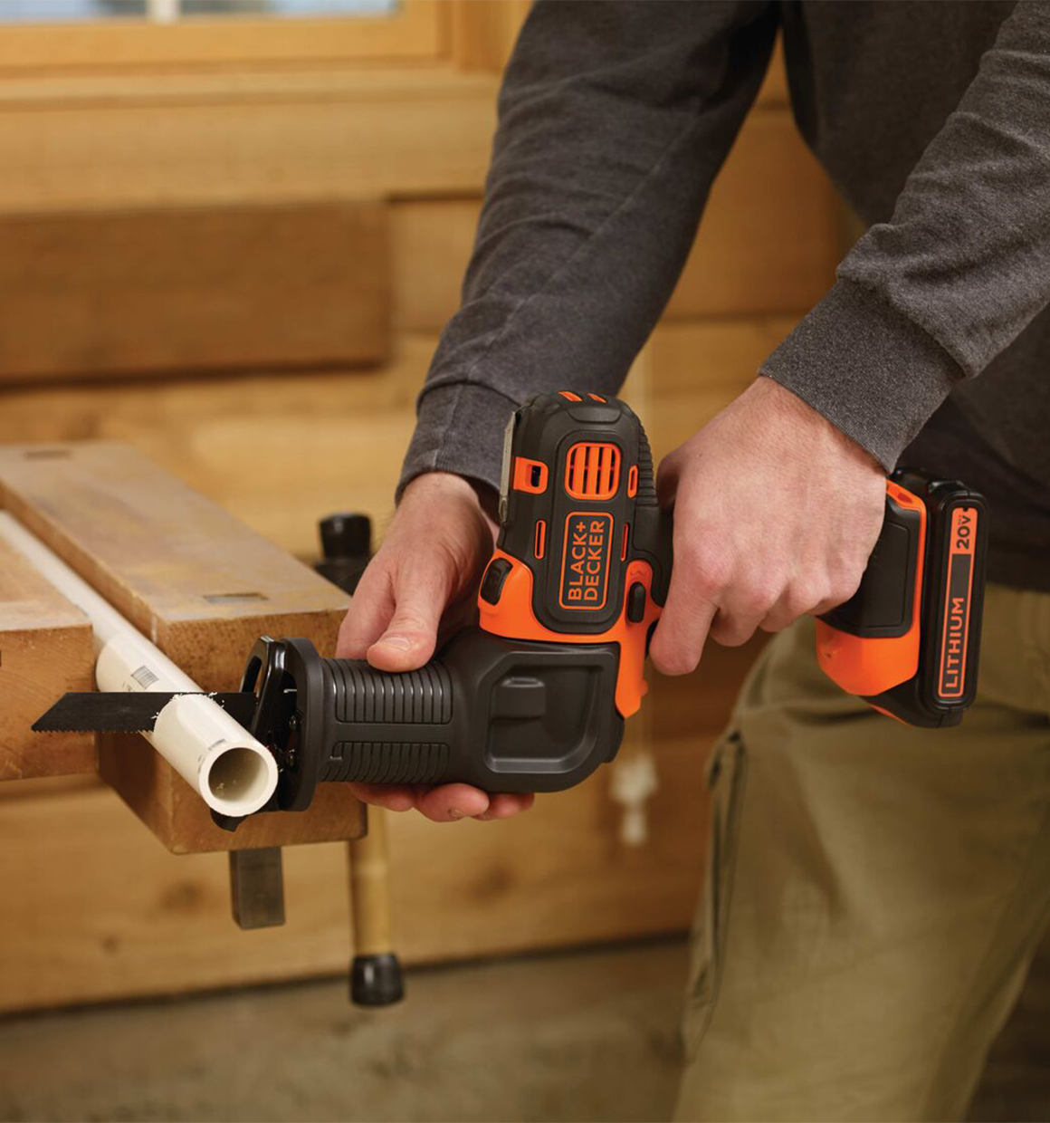 Black and Decker MATRIX Reciprocating Saw Accessory For Cordless Drill being used by a person to cut pvc.