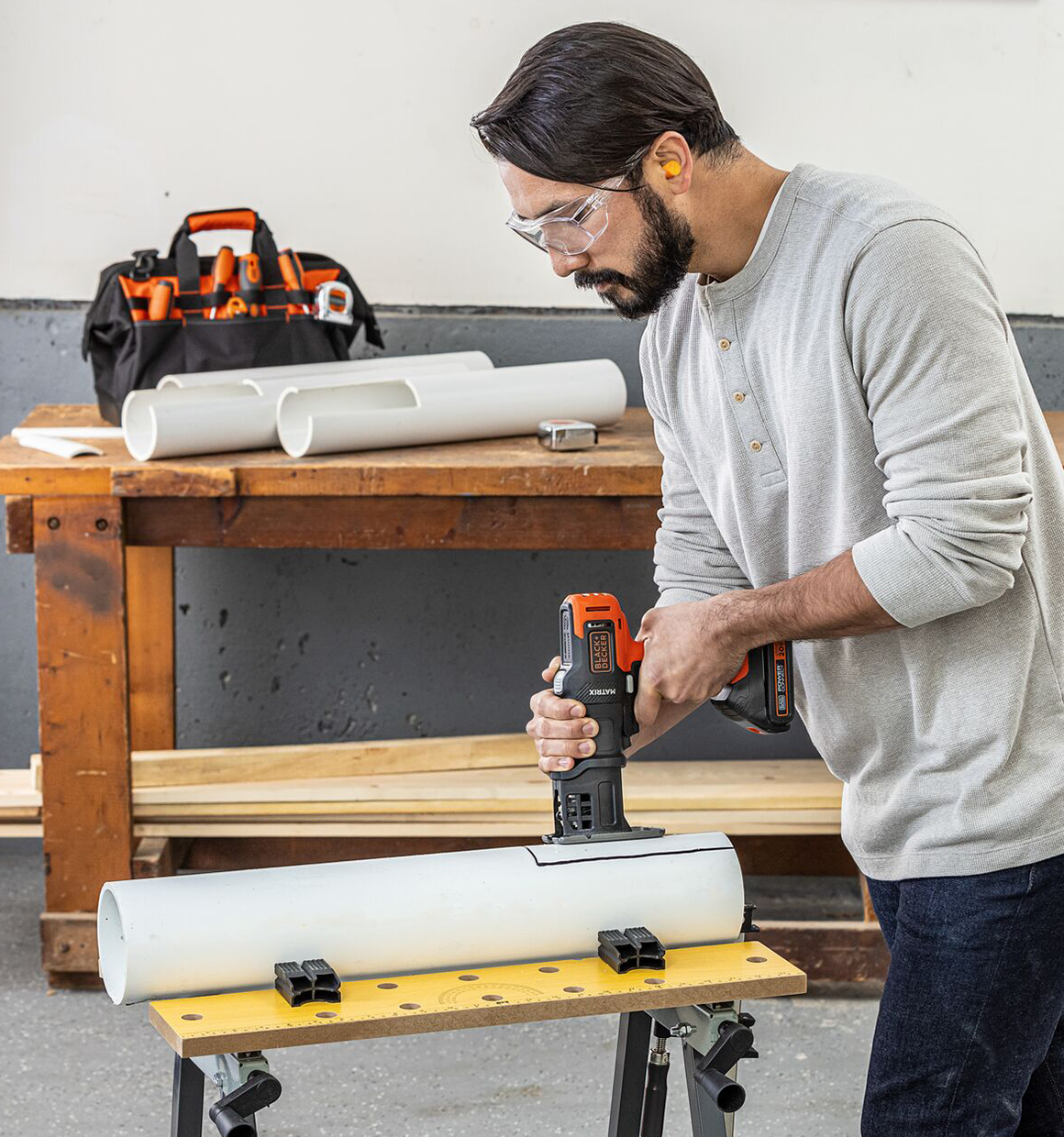 Person using Black and Decker Matrix jig saw attachment to cut pvc.