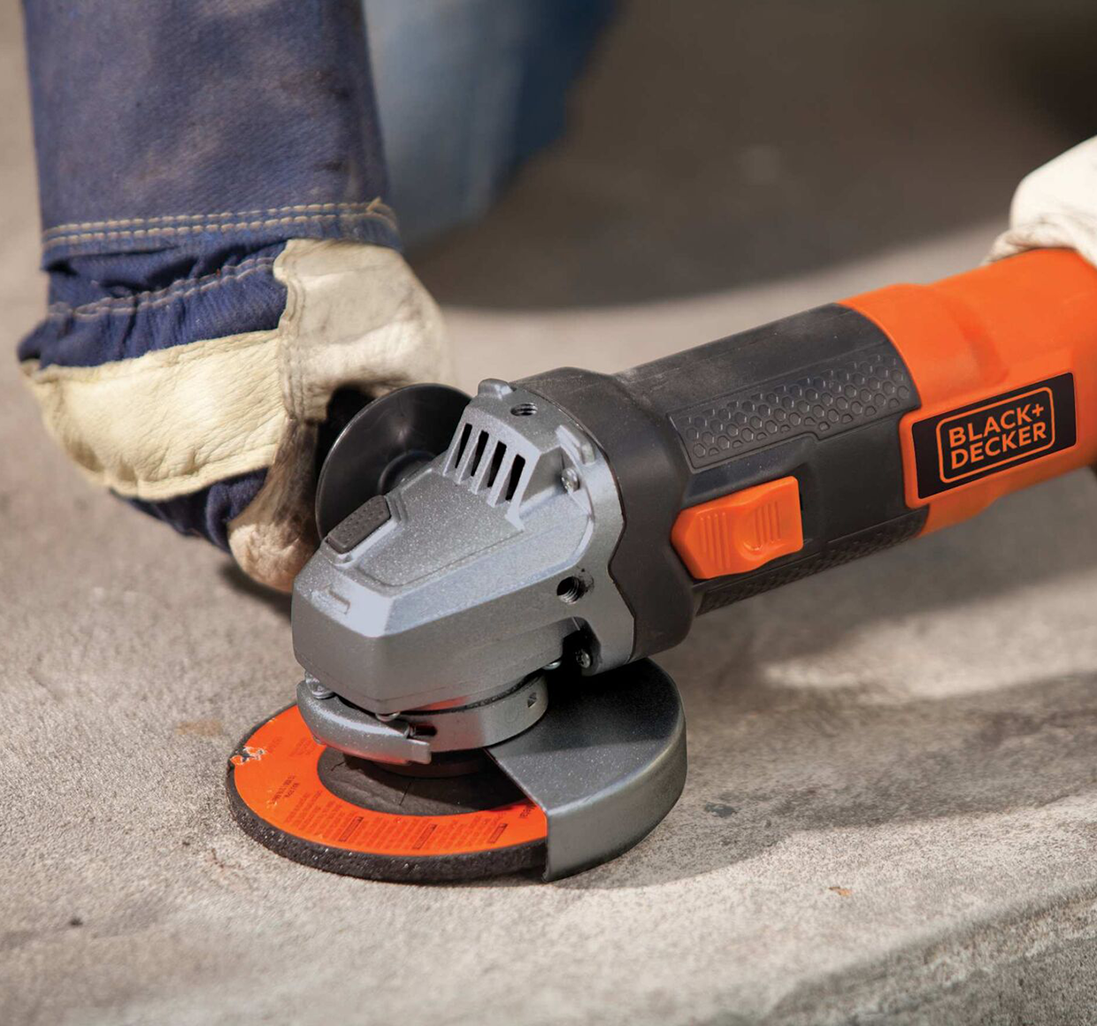 4 and half inch 6.5 Amp angle grinder being used by a person to grind hard surface.