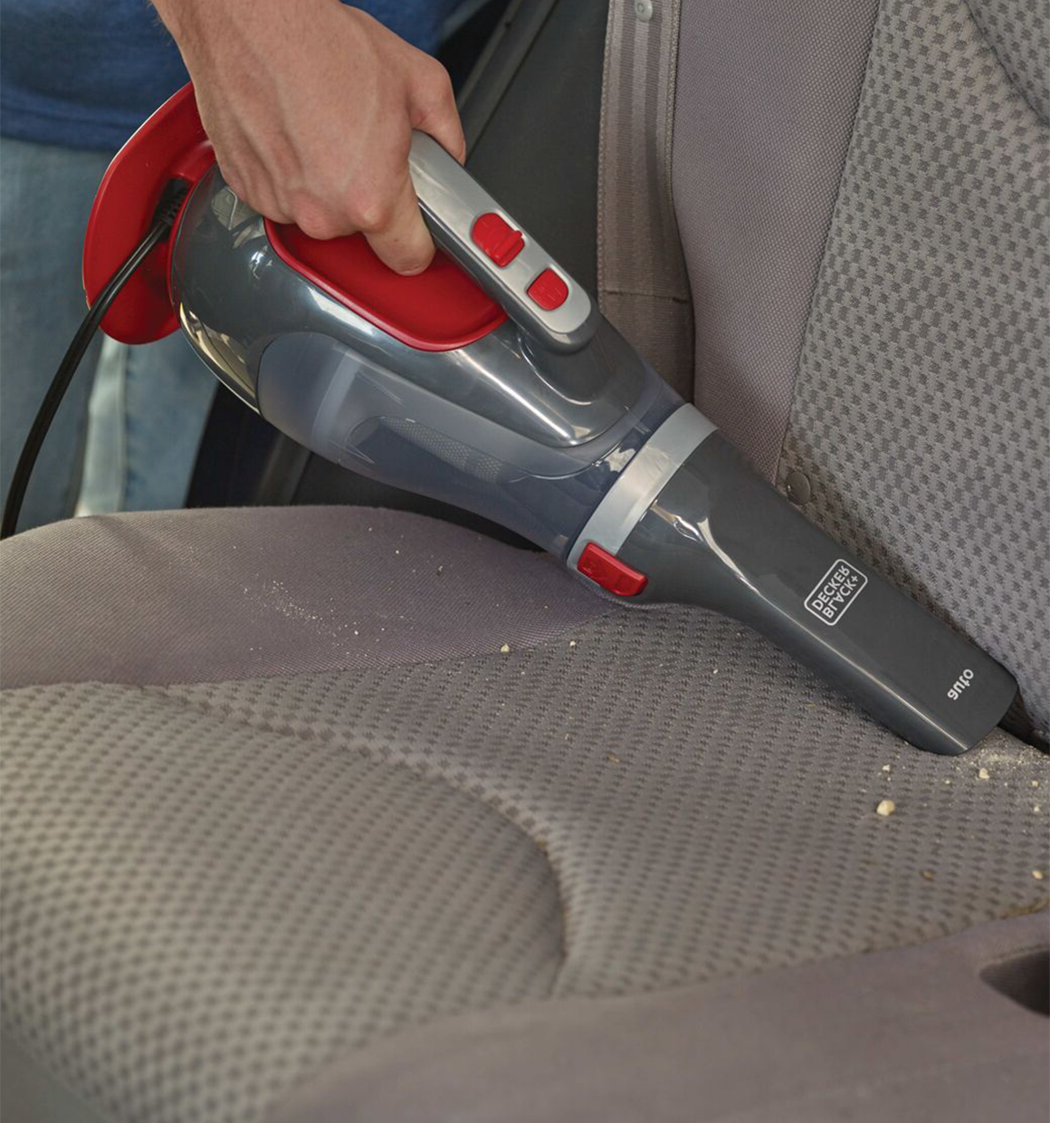 Dustbuster Car Handheld Vacuum being used for cleaning car seat.