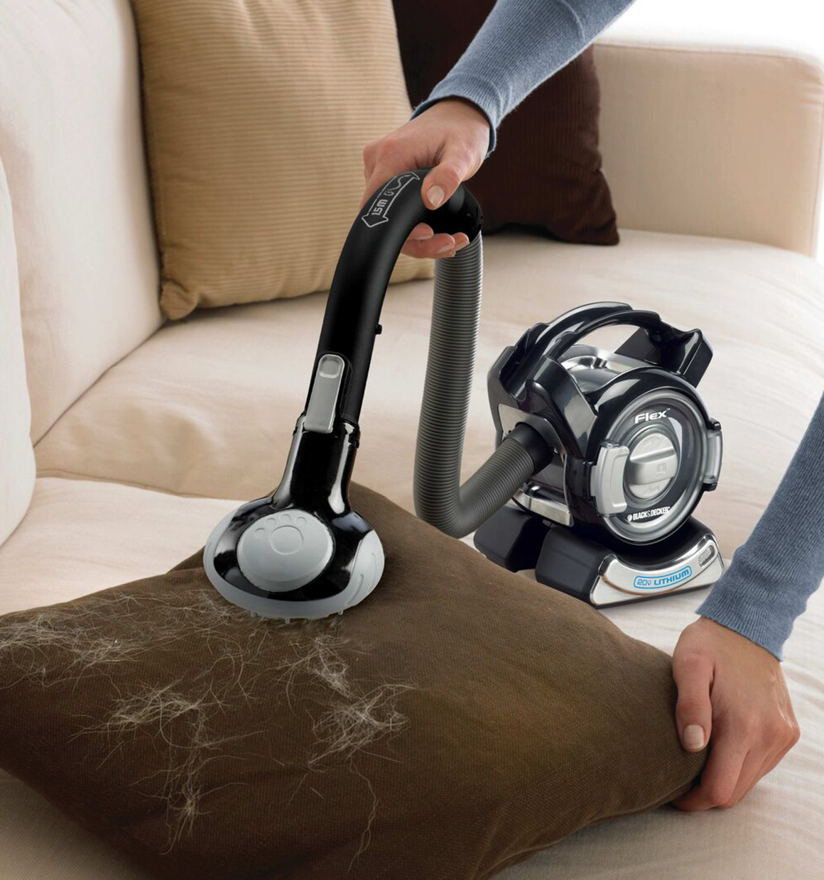 Dustbuster flex cordless hand vacuum with floor head plus pet hair brush being used by a person.
