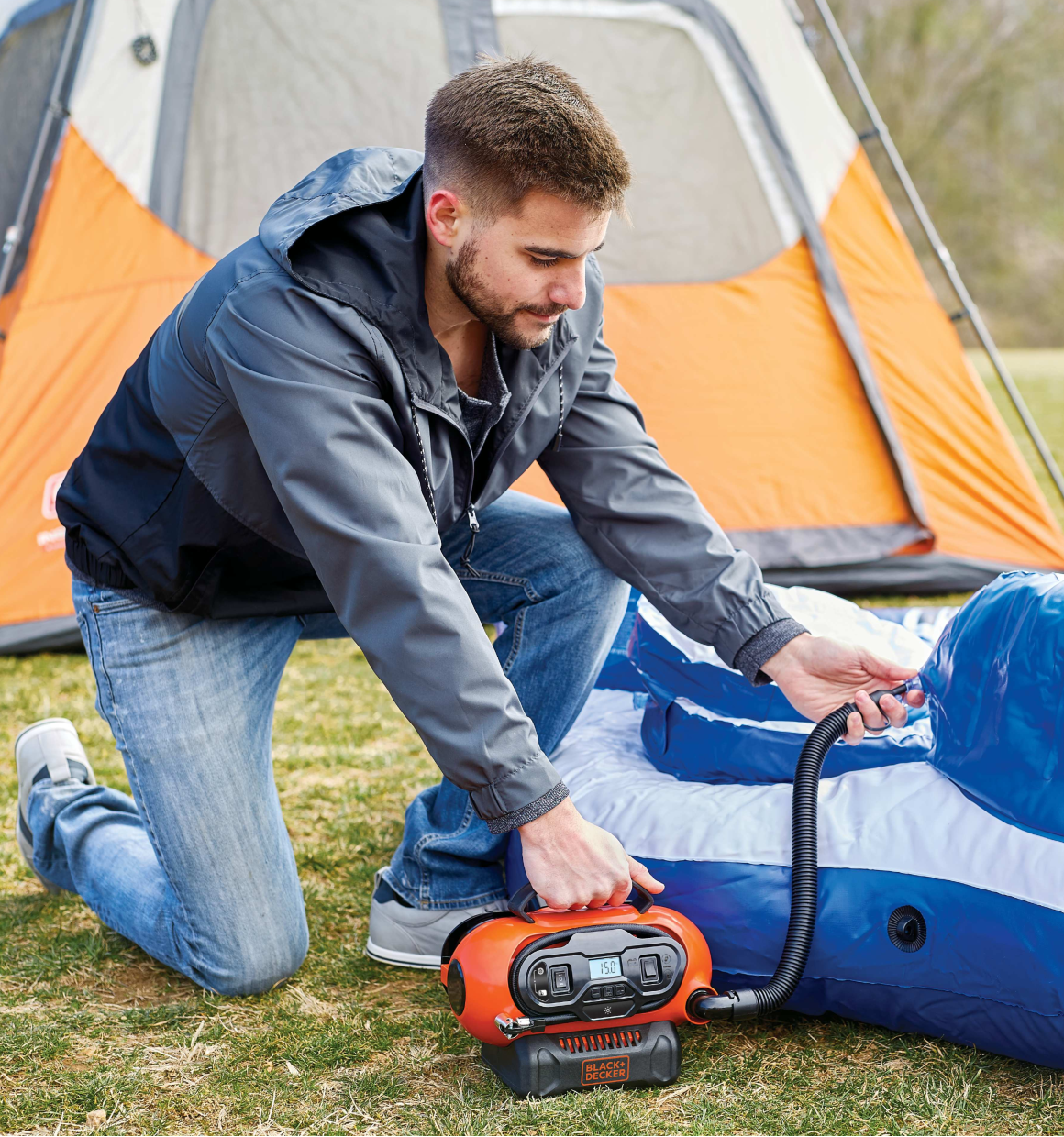 Multi Purpose Inflator being used by person to inflate campsite furniture.