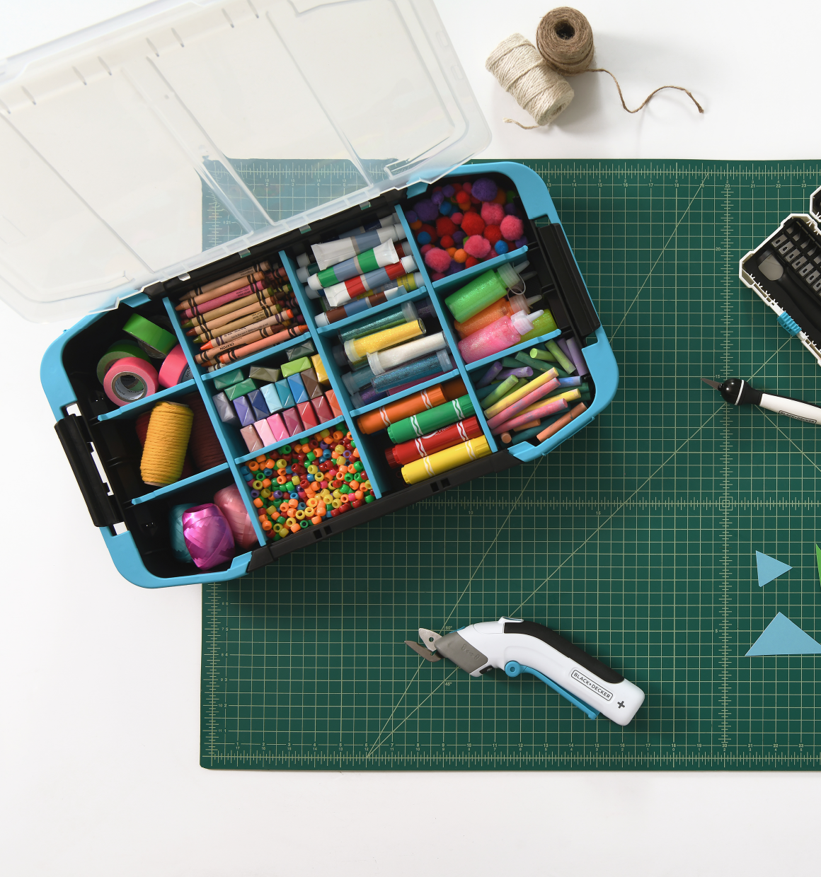 overhead view of the inside of the BLACK+DECKER crafting caddy sitting on a worktable next to other BLACK+DECKER crafting tools