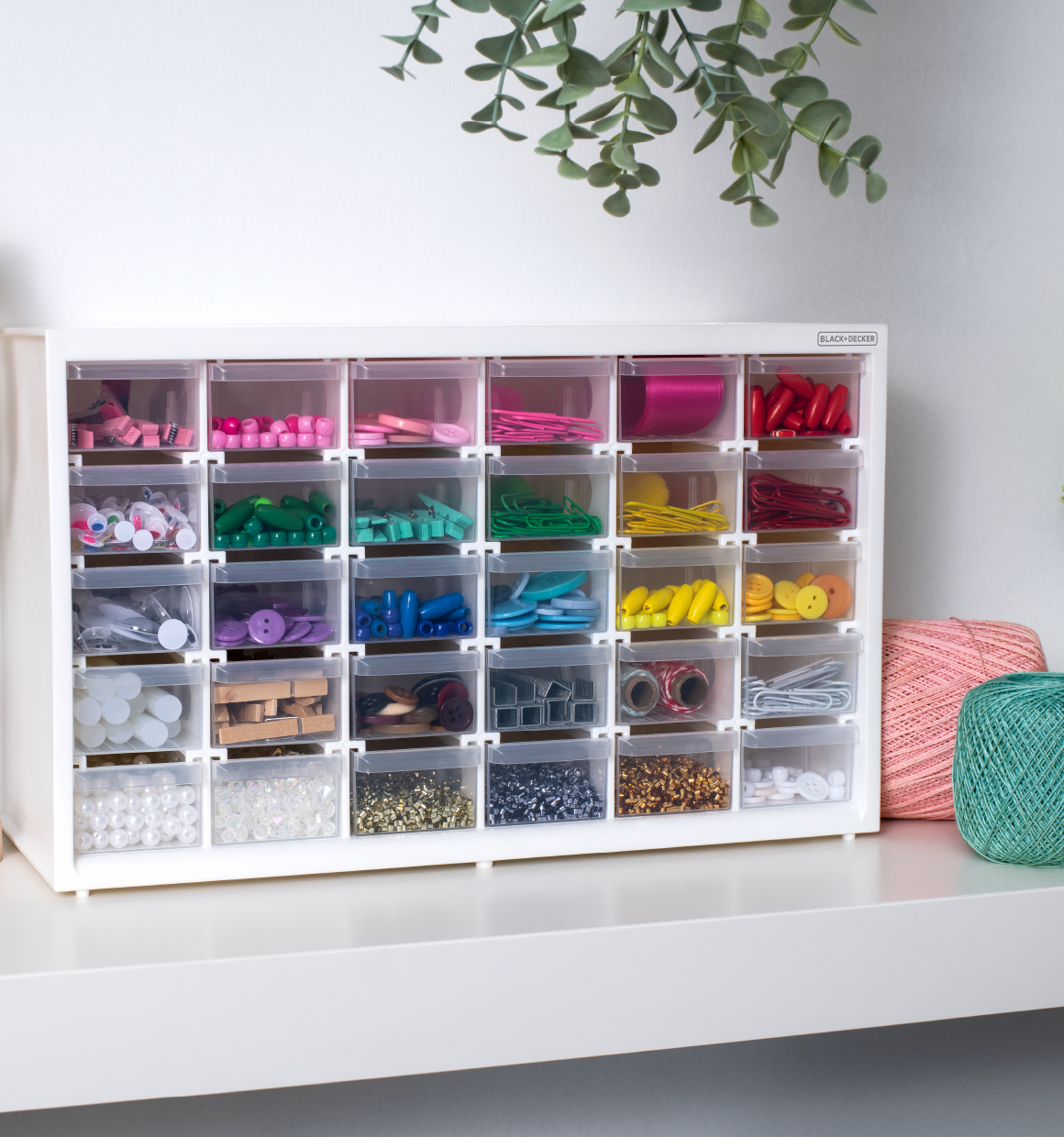 BLACK+DECKER 30 drawer material bin filled with various colorful crafting materials sitting on a shelf