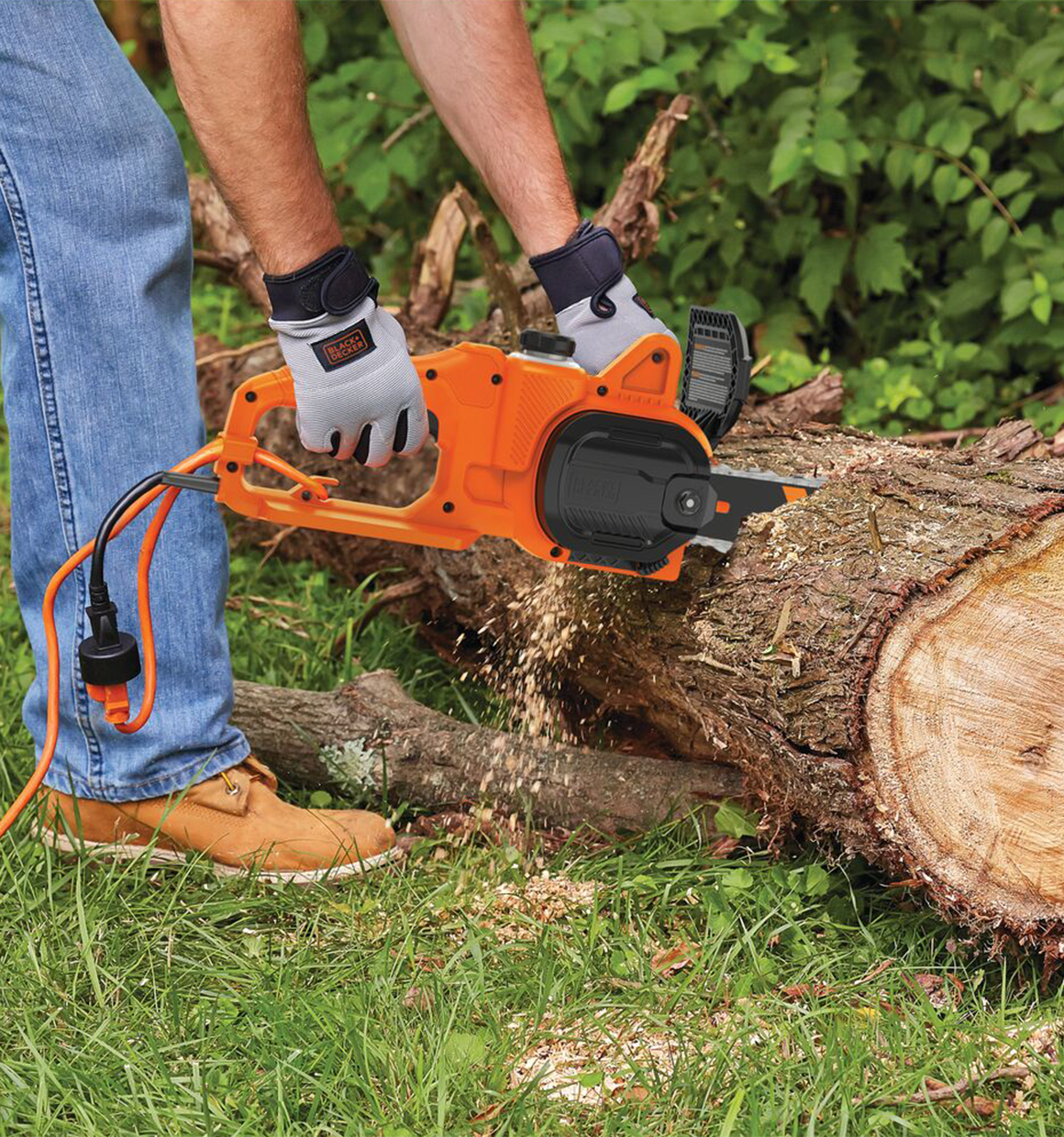 Person using Black and Decker 8 Amp 14 In. Electric Chainsaw to cut a log.