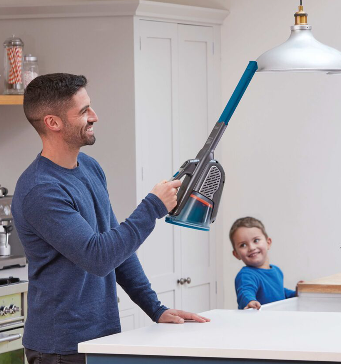 Person using Black and Decker DUSTBUSTER® 12V MAX* AdvancedClean™ Cordless Hand Vacuum to clean dust off of an overhead light fixture.