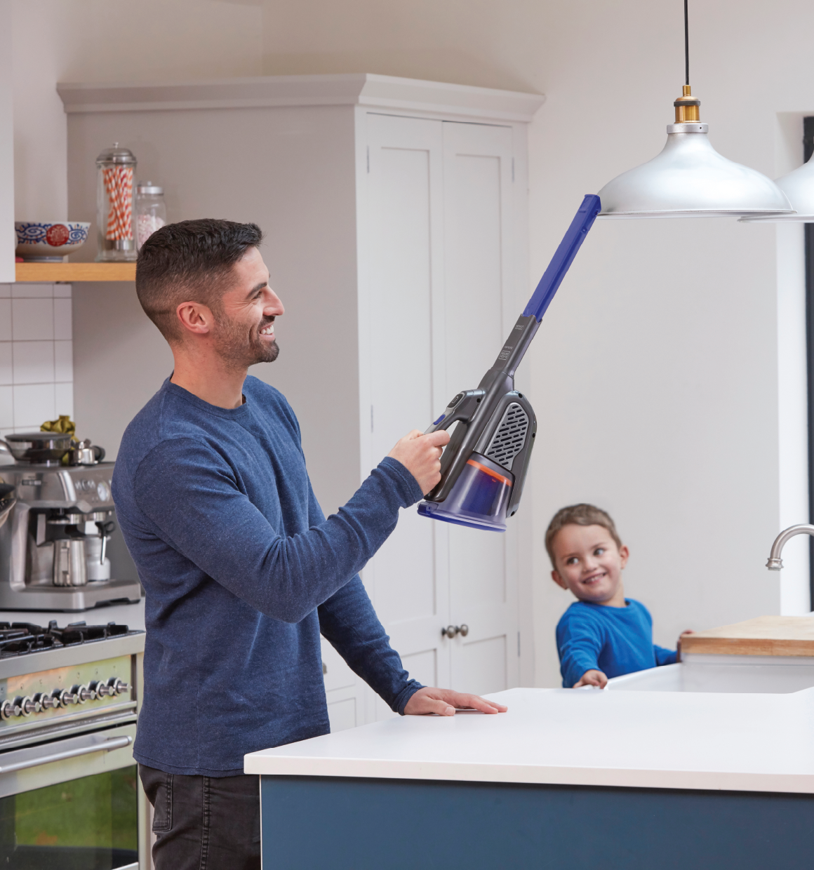 20 Volt dust buster Advanced Clean plus Pet Hand Vacuum With Base Charger and Extra Filter being used by person on hanging lights.