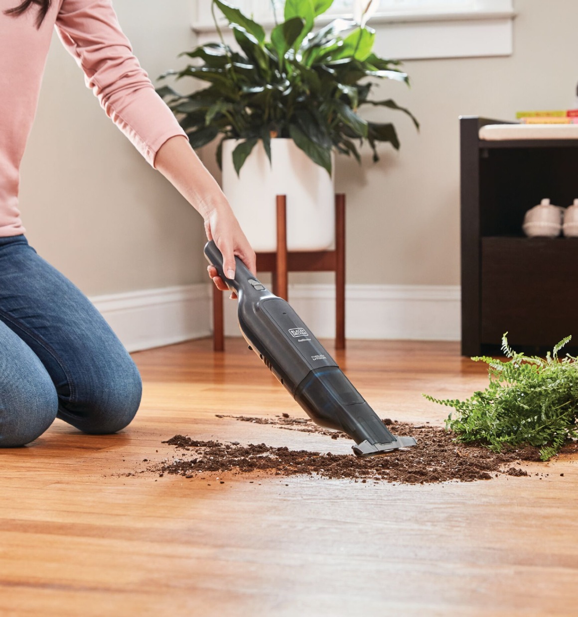 dustbuster 12V MAX Advanced Clean Cordless Hand Vacuum being used to clean dirt from floor.