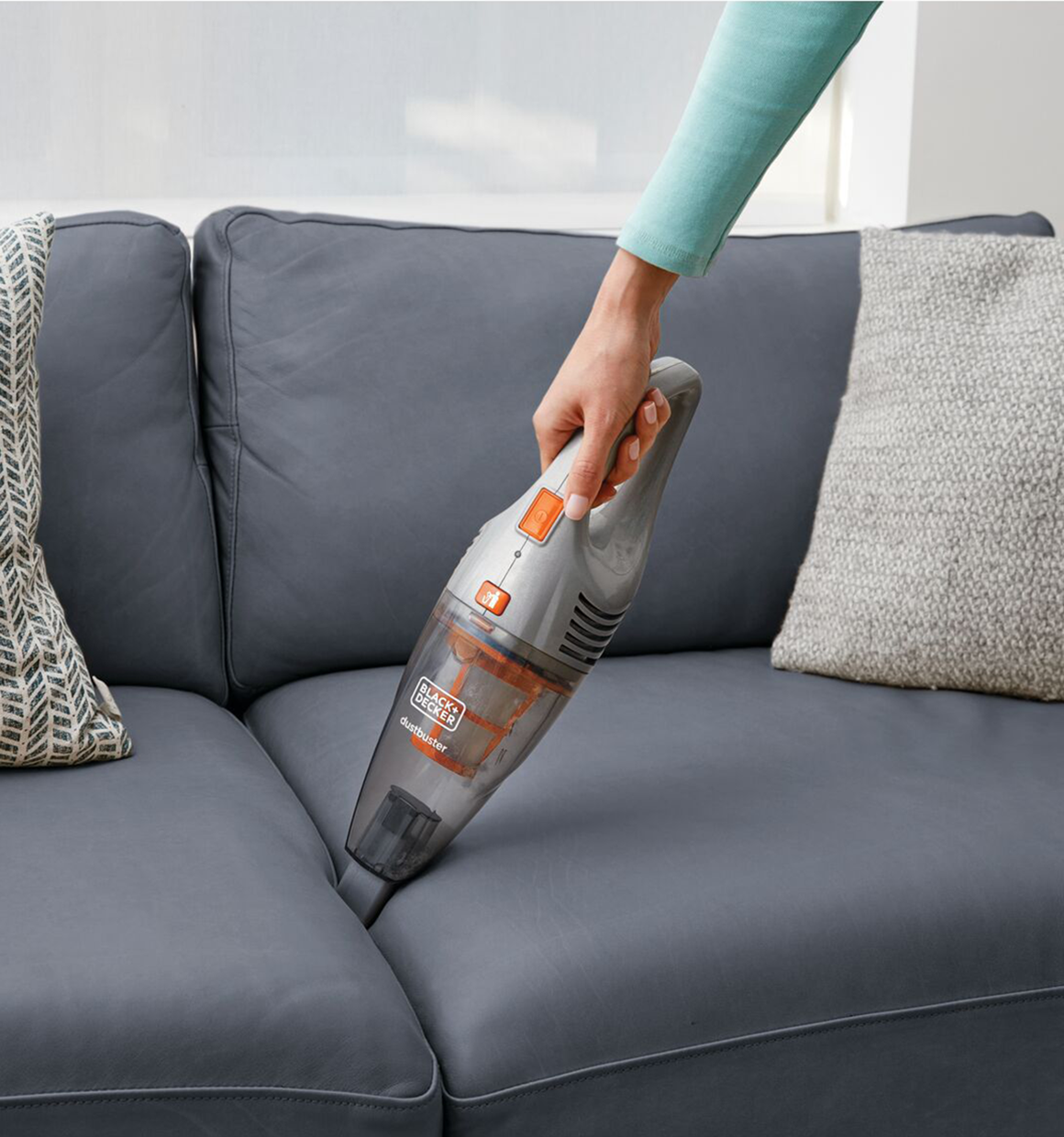 POWER SERIES 2 in 1 Cordless Stick Vacuum being used in between sofa cushions.