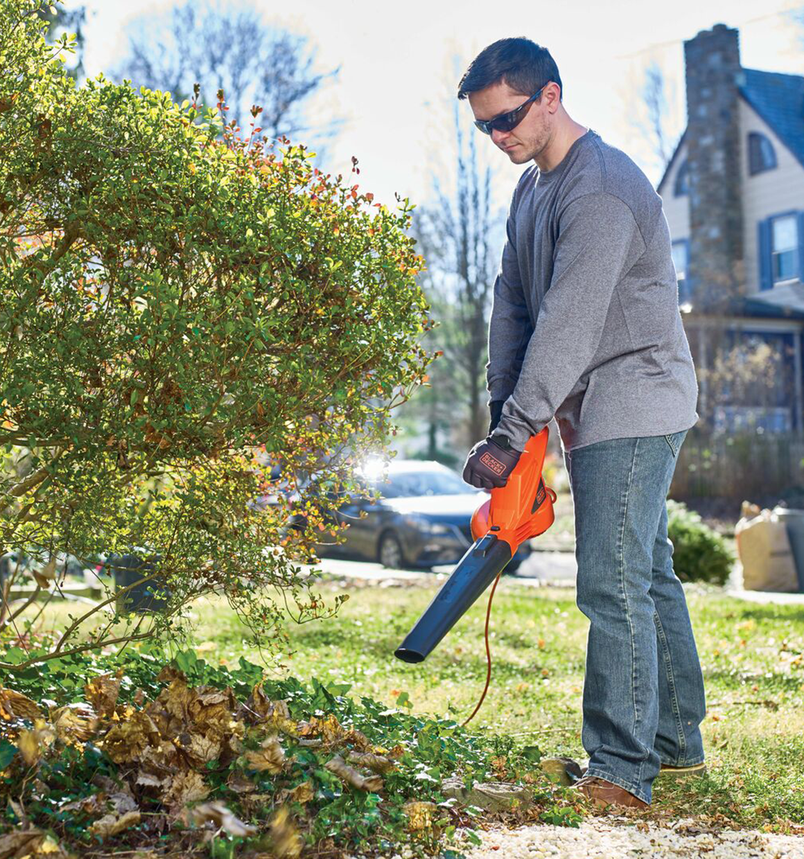 7 Amp blower being used by a person to clean yard.