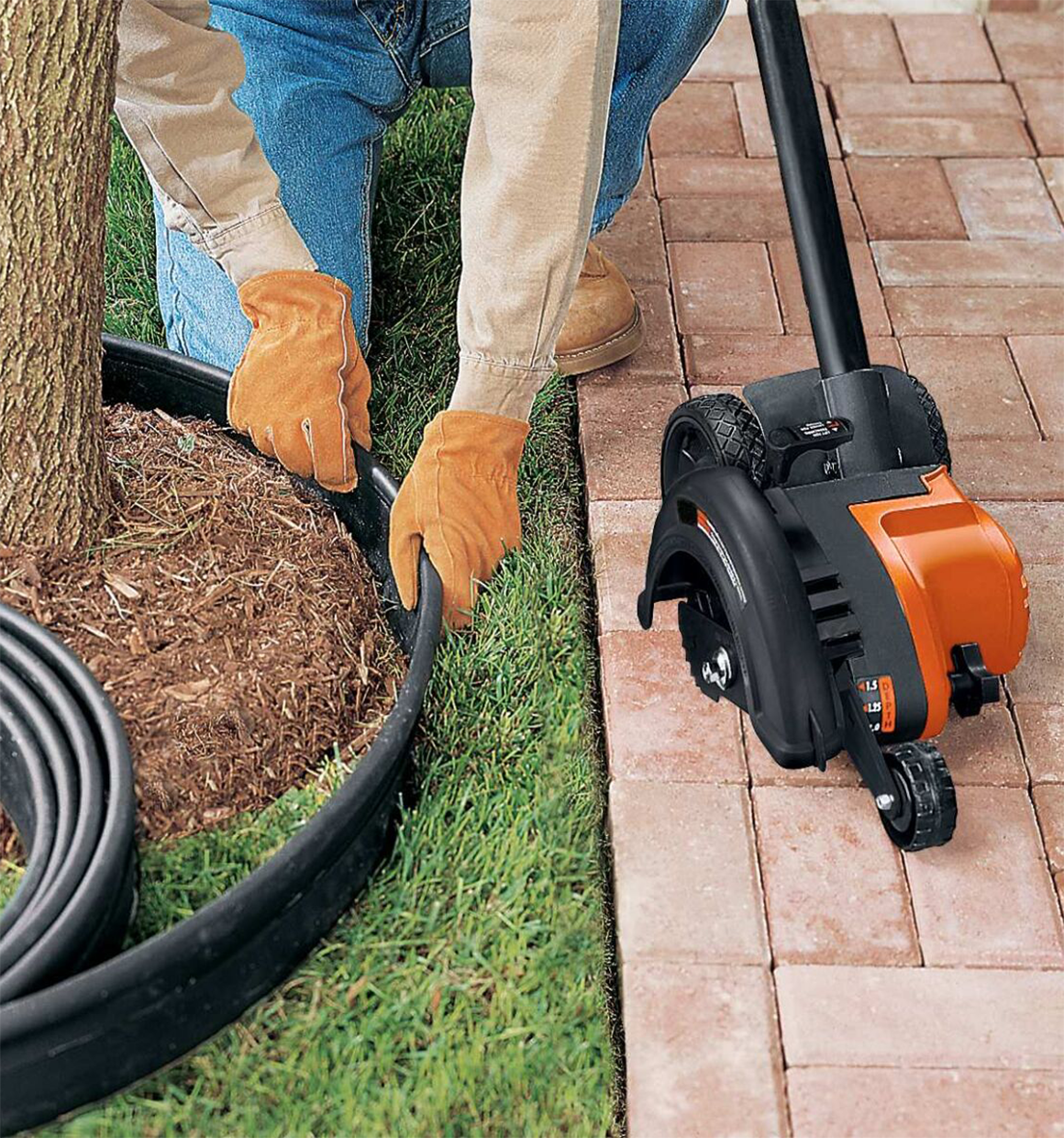 2 in 1 Landscape Edger and Trencher on a walkway next to a person setting up edging.
