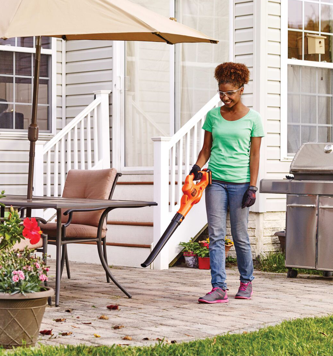 20 Volt Lithium Sweeper being used by a person in a garden