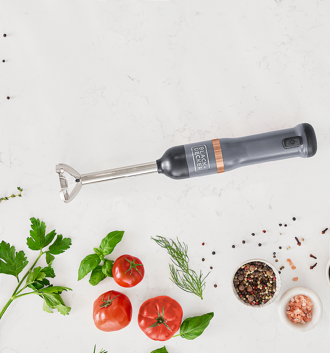 Laydown view of the grey, BLACK+DECKER kitchen wand immersion blender kit