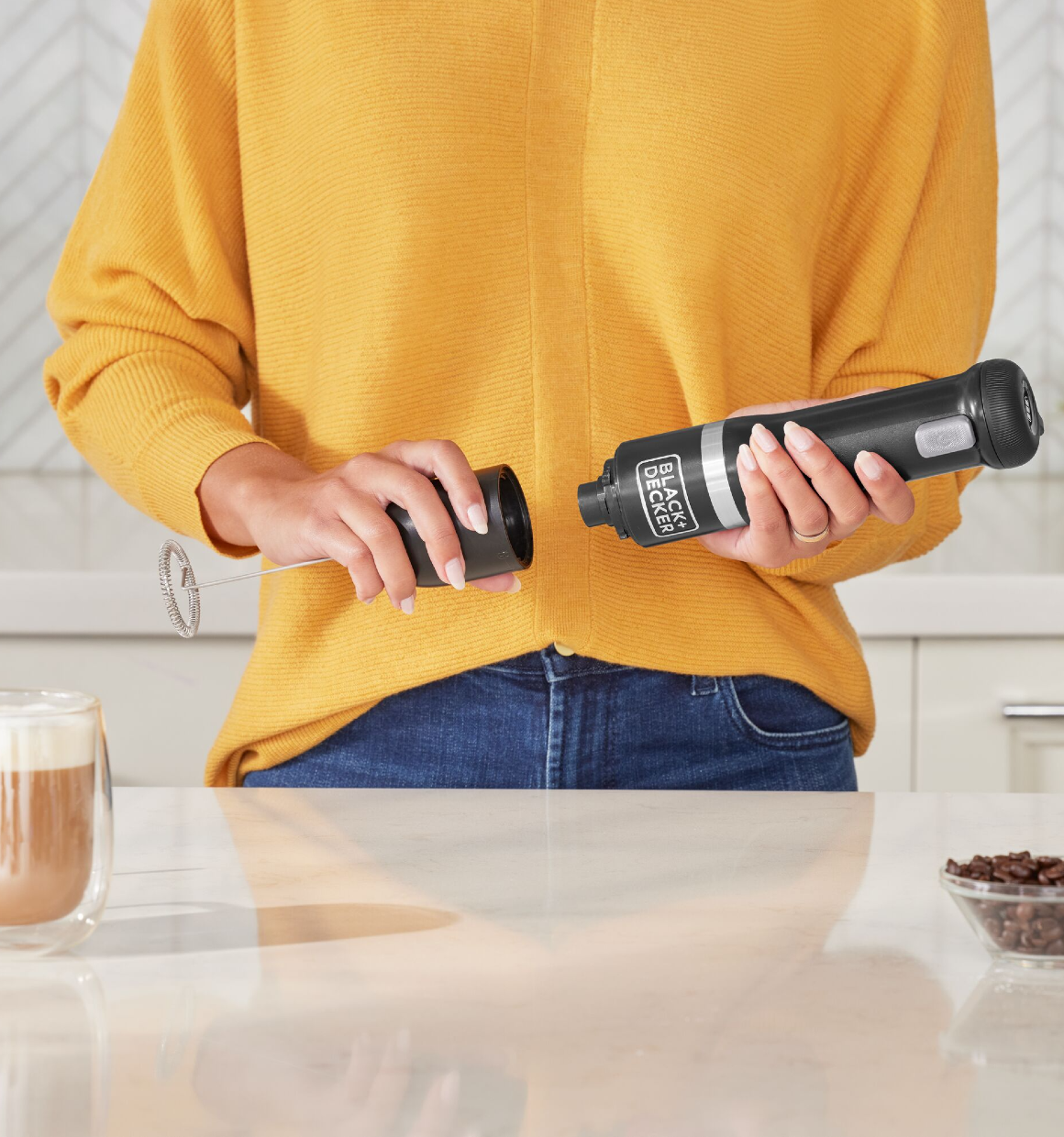Talent showing how to attach the BLACK+DECKER kitchen wand milk frother attachment to the black power unit