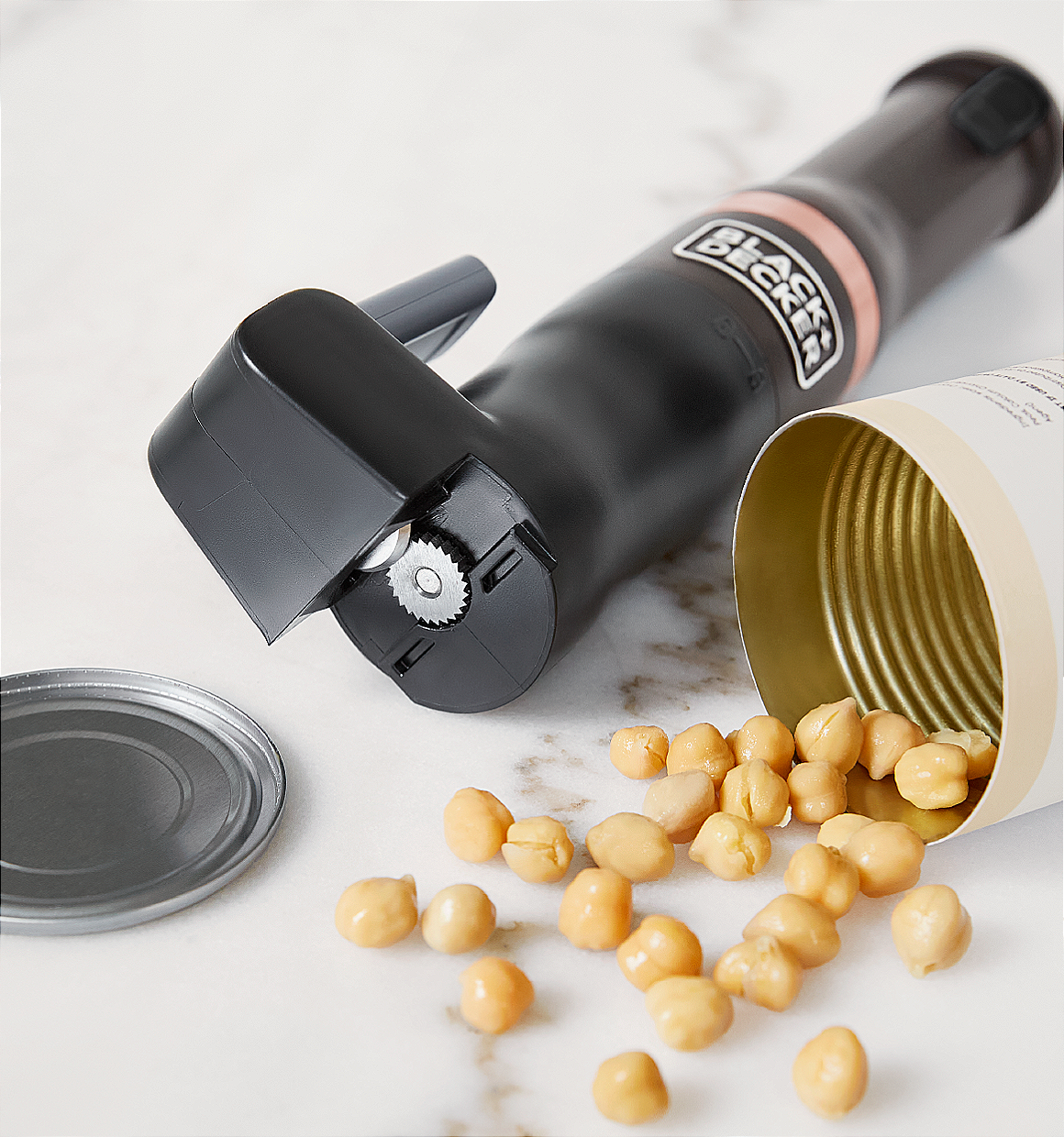 Can of opened chickpeas lying next to the grey. BLACK+DECKER kitchen wand can opener