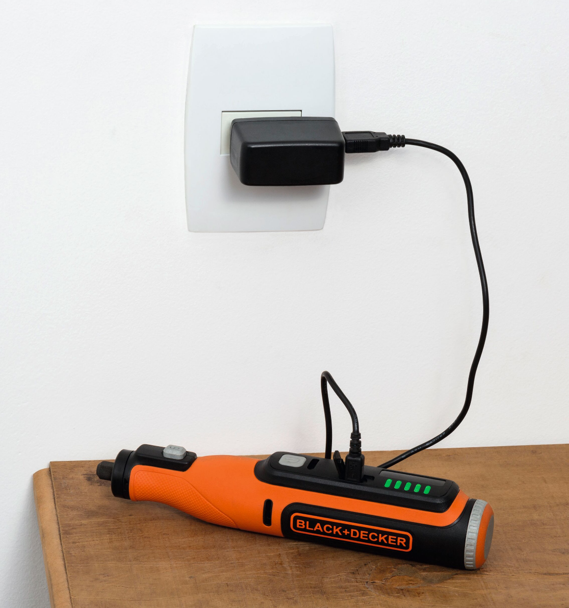 8V Max Rotary Tool plugged into wall outlet to charge.