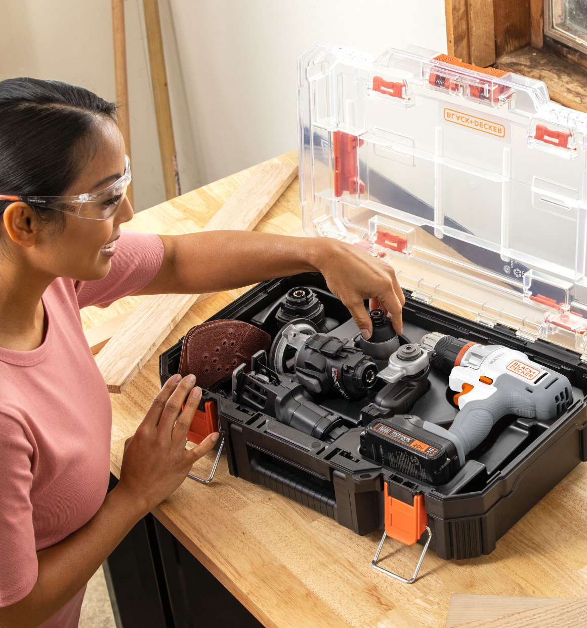 Woman opening the 20V Max Matrix Cordless Drill 6-Tool Combo Kit case to select a tool.
