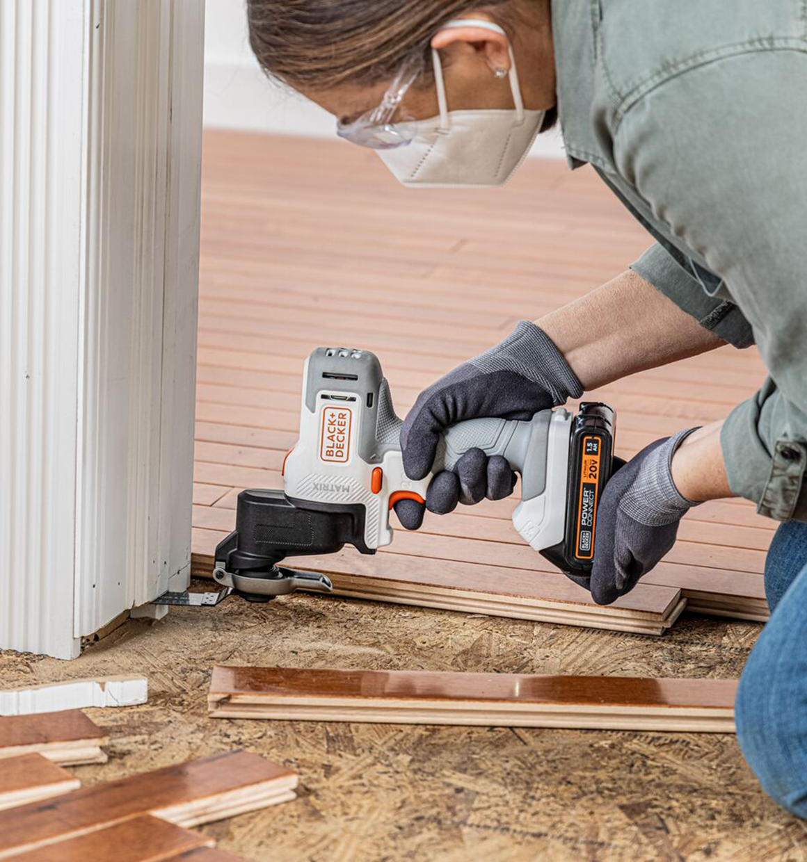 Black and Decker Matrix Oscillating Tool Attachment being used by a person to cut trim.