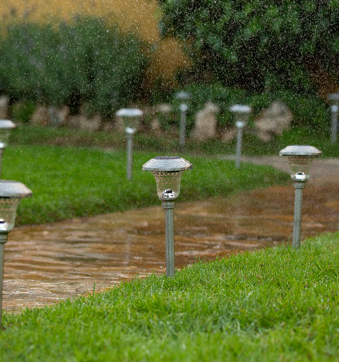 BLACK+DECKER Path Lights along a path in the rain