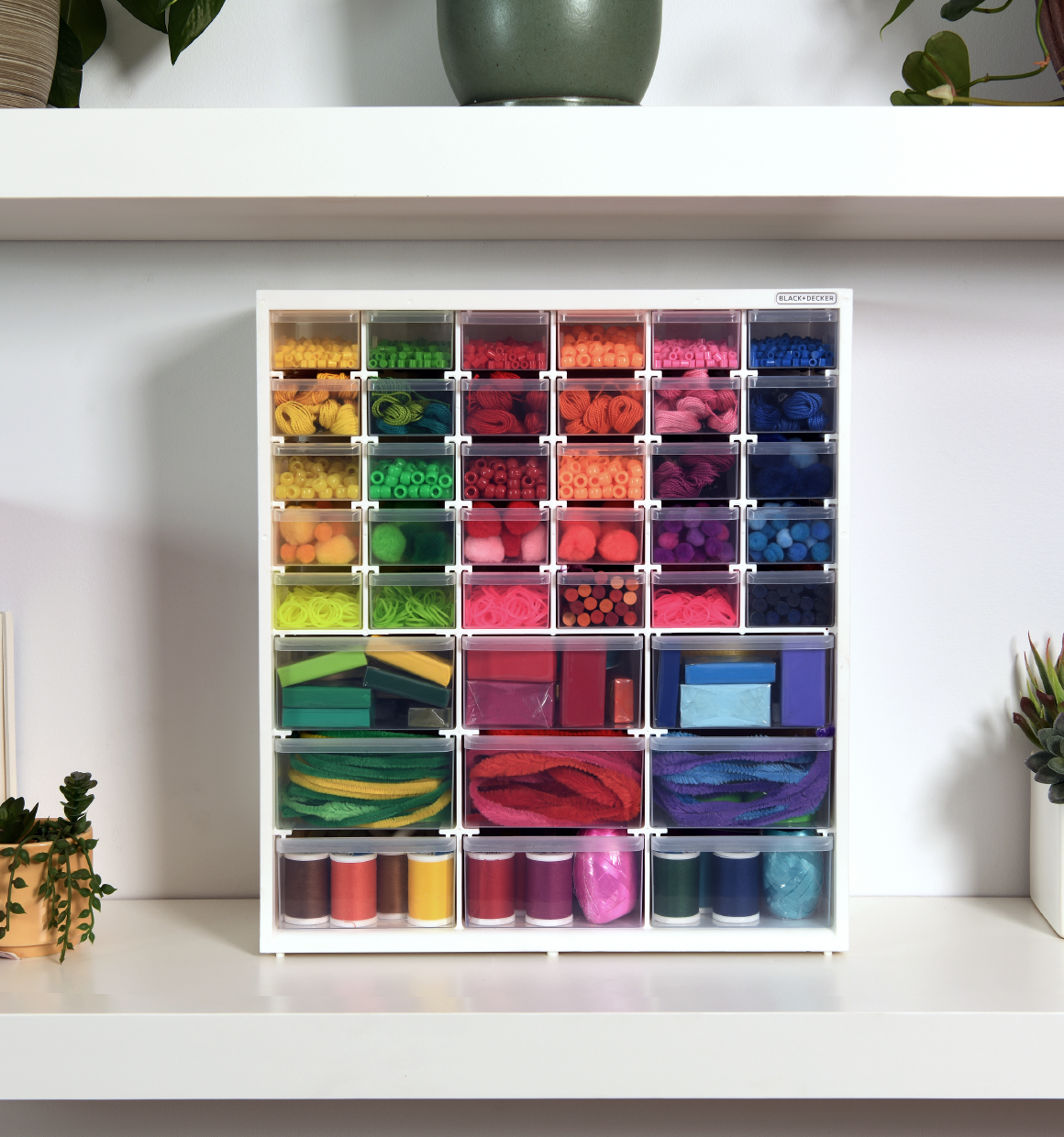 BLACK+DECKER 39 Drawer Organizer Bin filled with various colorful crafting materials sitting on a shelf