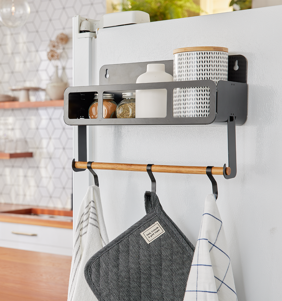 Hanging Rack System-Shelf W/Brackets hanging on a fridge with spices and towels.