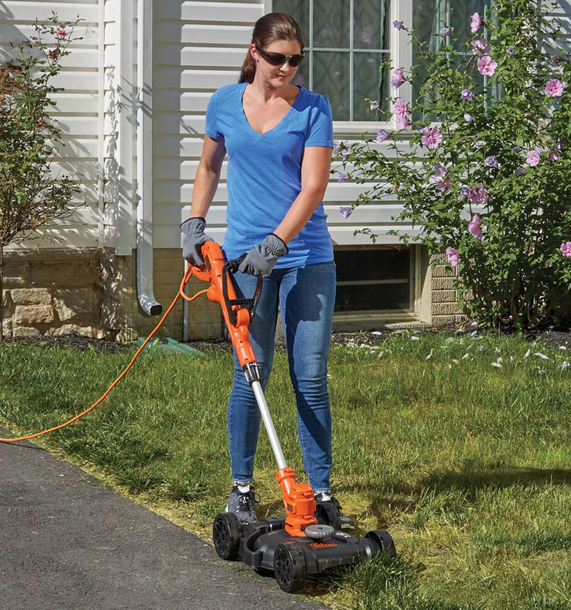 12 inch 3 in 1 Compact Electric Lawn Mower being used by person to mow lawn outdoors.